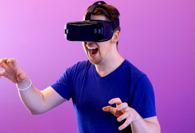 Photo of a man wearing VR glasses